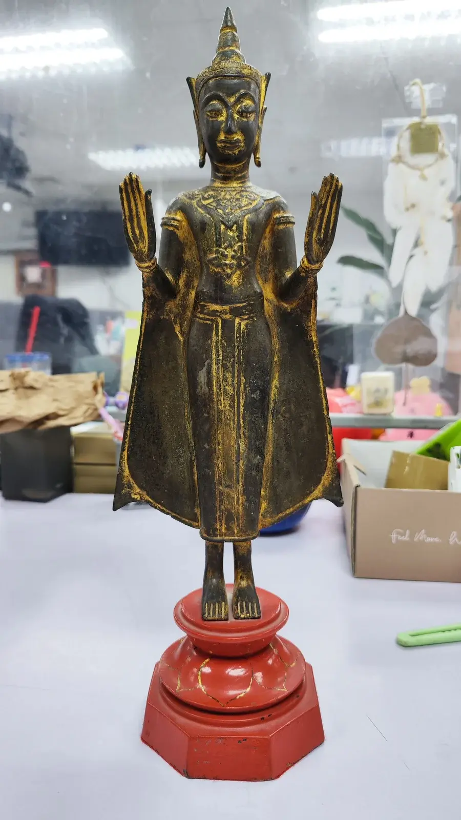 A standing Buddha figure from an artifact clearance job