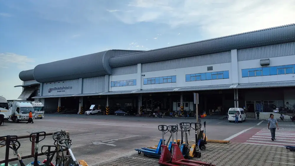 Express cargo terminal with courier vehicles and cargo trolleys
