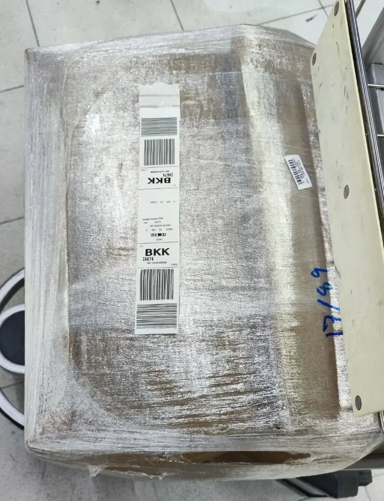 Wrapped passenger shipment with a BKK airport baggage label